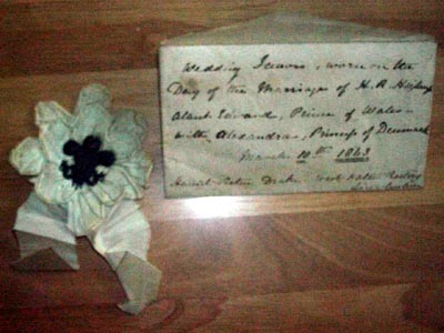 white ribbon with the three feathers